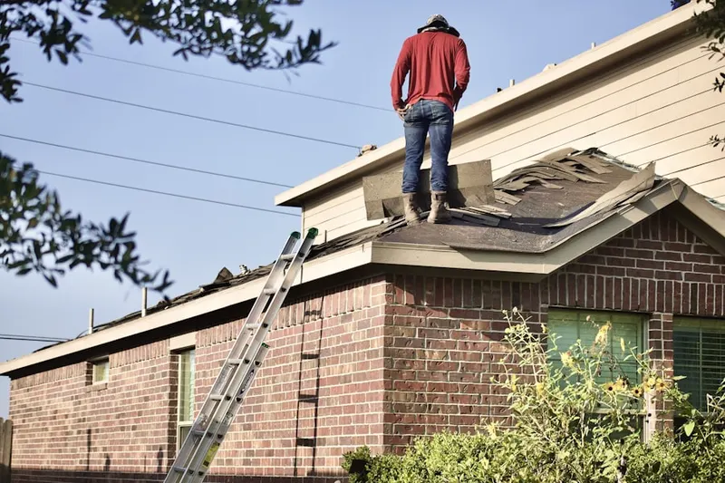 Professional roofer working on a residential roof in Norway